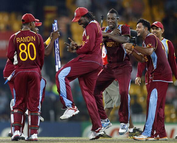 West Indies' cricketer Chris Gayle, center, dances with teammates to celebrate their win over Australia in the ICC Twenty20 Cricket World Cup semifinal match in Colombo.