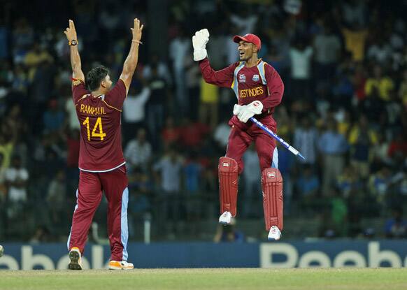 West Indies' wicketkeeper Denesh Ramdin, right, and bowler Ravi Rampaul celebrate their teams' victory over Australia by 76 runs in the ICC Twenty20 Cricket World Cup semi final match between Australia and West Indies' in Colombo.