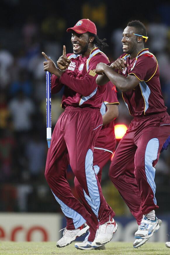 Chris Gayle and Andre Russell dance after West Indies beat Australia during the ICC Twenty20 Cricket World Cup semifinal match in Colombo.