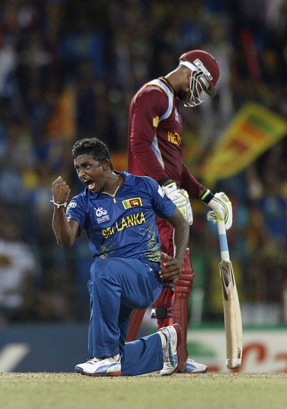 Sri Lanka's bowler Ajantha Mendis, left, celebrates the dismissal of West Indies' batsman Andre Russell, not seen, during the ICC Twenty20 Cricket World Cup final match in Colombo.