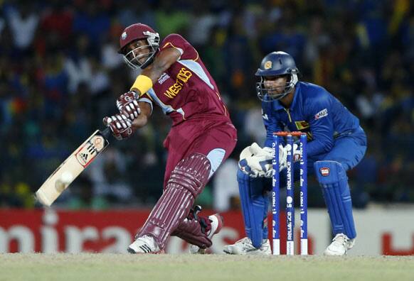 West Indies' batsman Dwayne Bravo plays a shot as Sri Lankan wicketkeeper Kumar Sangakkara, right, watches during their ICC Twenty20 Cricket World Cup final match between Sri Lanka and West Indies' in Colombo.