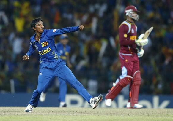 Sri Lankan bowler Akila Dananjaya celebrates the wicket of West Indies' batsman Marion Samuels, right, during their ICC Twenty20 Cricket World Cup final match between Sri Lanka and West Indies' in Colombo, Sri Lanka.