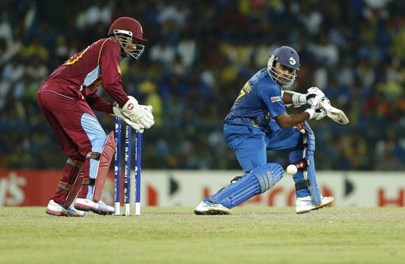 Sri Lankan captain Mahela Jayawardene plays a shot in front of West Indies' wicketkeeper Denesh Ramdin during their ICC Twenty20 Cricket World Cup final match between Sri Lanka and West Indies' in Colombo.