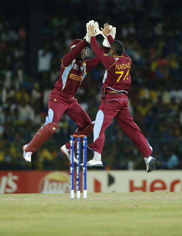 West Indies' wicketkeeper Denesh Ramdin, left, and bowler Sunil Narine celebrate the dismissal of Sri Lanka's captain Mahela Jayawardene, unseen, during their ICC Twenty20 Cricket World Cup final match between Sri Lanka and West Indies' in Colombo.