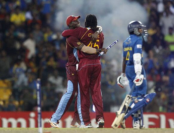 West Indies' captain Darren Sammy, left, hugs teammate Chris Gayle to celebrate their win over Sri Lanka in the ICC Twenty20 Cricket World Cup final match in Colombo, Sri Lanka.