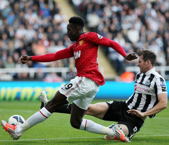 Manchester United's Danny Welbeck, left, has a shot toward's goal past Newcastle United's Mike Williamson, right,during their English Premier League soccer match at the Sports Direct Arena.