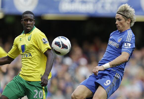 Chelsea's Fernando Torres, right, controls the ball in front of Norwich City's Leon Barnett during an English Premier League soccer match at Stamford Bridge ground in London.