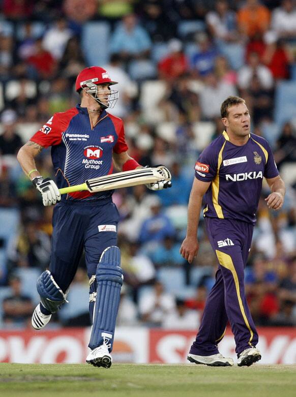 Delhi Daredevils's batsman Kevin Pietersen, left, makes a run off Kolkata Knight Riders's bowler Jacques Kallis, right, bowling during the Champions League Twenty20 cricket match at the Centurion Park in Pretoria.