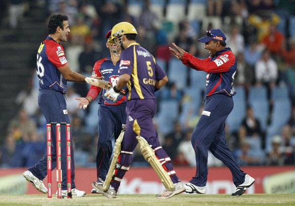 Delhi Daredevils's bowler Irfan Pathan, left, celebrates with teammates after dismissing Kolkata Knight Riders's captain Gautam Gambhir, center, during the Champions League Twenty20 cricket match at the Centurion Park in Pretoria.