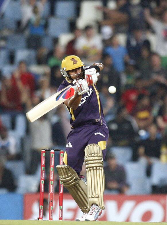 Kolkata Knight Riders's batsman Manoj Tiwary plays a shot from Delhi Daredevils's bowler Umesh Yadav, unseen, during the Champions League Twenty20 cricket match at the Centurion Park in Pretoria, South Africa.