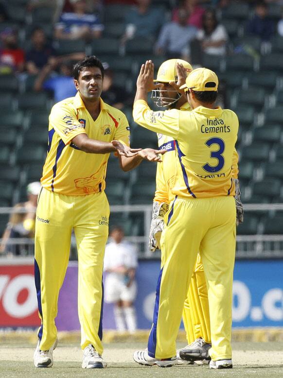 Chennai Super Kings bowler Ravichandran Ashwin, left, celebrates with teammates after bowling Sydney Sixers batsman Nic Maddinson, unseen, for 12 runs during the Champions League Twenty20 cricket match at the Wanderers Stadium.