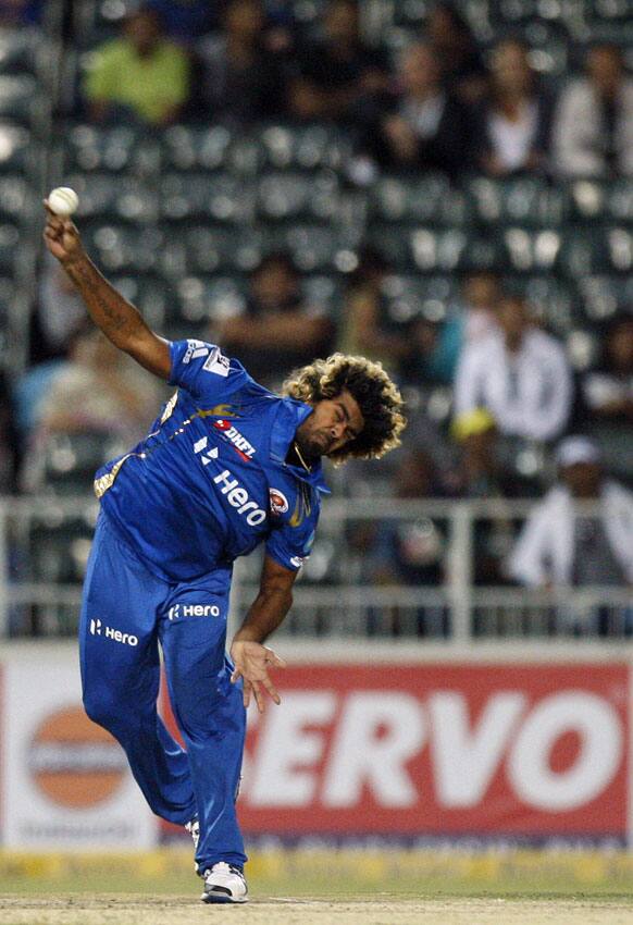 Mumbai Indians bowler Lasith Malinga in delivery against Highveld Lions captain Alviro Petersen, unseen, during the Champions League Twenty20 cricket match at the Wanderers Stadium, Johannesburg, South Africa.