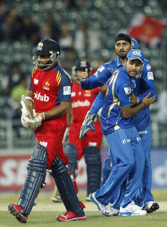 Mumbai Indians bowler Harbhajan Singh, right, celebrates with teammate after dismissing Highveld Lions batsman Gulam Bodi, left, for 19 runs during the Champions League Twenty20 cricket match at the Wanderers Stadium, Johannesburg.