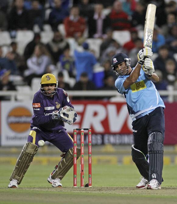 Auckland Aces Azhar Mahmood, right, plays a shot during the Champions League Twenty20 cricket game against Kolkata Knight Riders in Cape Town, South Africa.