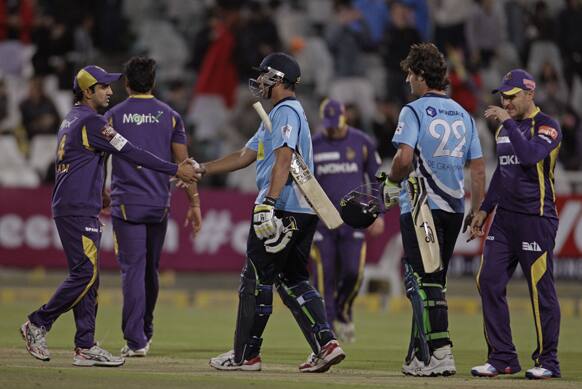 Auckland Aces Azhar Mahmood, center, and team mate Colin de Grandhomme, second right, as they win there game during the Champions League Twenty20 cricket game against Kolkata Knight Riders in Cape Town.