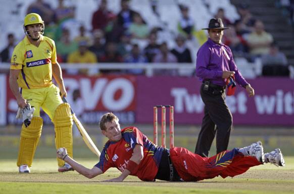 Highveld Lions Chris Morris, center, throws the ball at the wicket of Chennai Super Kings Murali Vijay, unseen, during the Champions League Twenty20 in Cape Town.