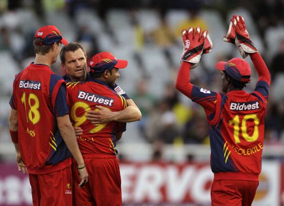 Highveld Lions Thami Tsoleklie, right, celebrates with team members after they took the wicket of Chennai Super Kings Albie Morkel, unseen, during the Champions League Twenty20 in Cape Town, South Africa.