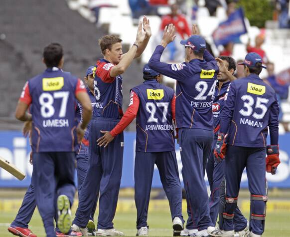 Perth Scorchers Herschelle Gibbs, unseen, looses his wicket as Delhi Daredevils Morne Morkel, second left, reacts with team members during a Champions League Twenty20 game in Cape Town, South Africa.