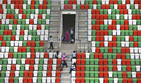 Indian private security guards and workers rest on the stands of the Buddh International Circuit in Noida, on the outskirts of New Delhi.