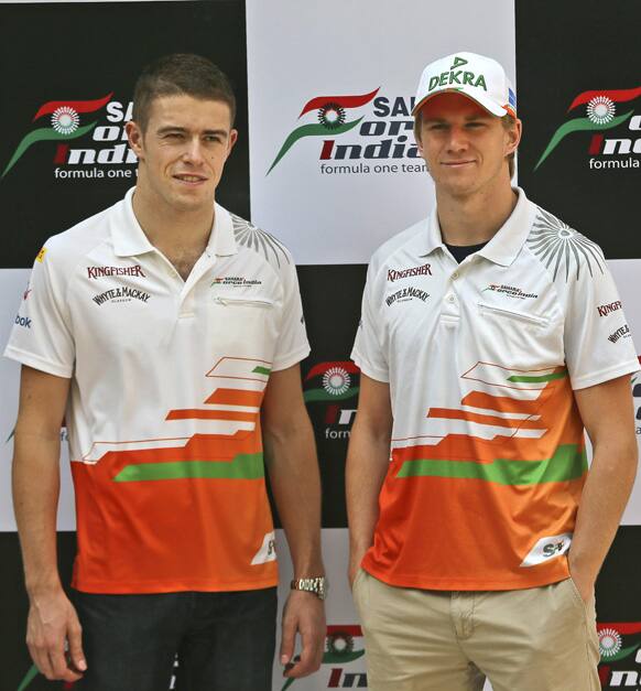 Force India Formula One team Nico Hulkenberg of Germany, right, and Paul Di Resta of Britain pose for a photo before a press conference, in New Delhi, India.