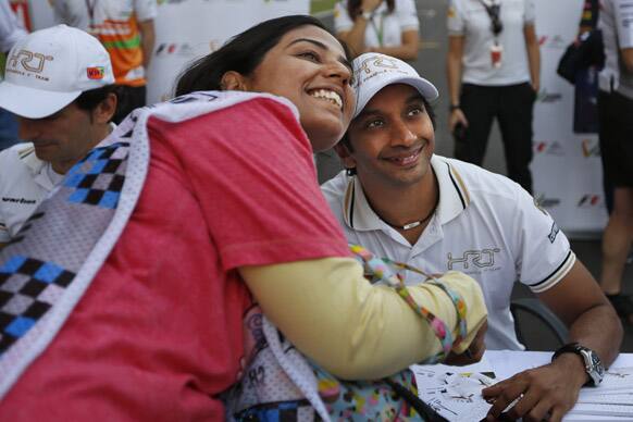 Hispania Racing Team driver Narain Karthikeyan of India poses for a photograph with a fan ahead of the Indian Formula One Grand Prix at the Buddh International Circuit in Noida.