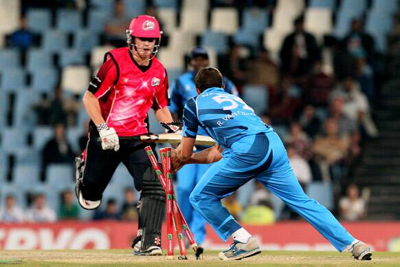 Titans' bowler Roelof van der Merwe, right, runs out Sydney Sixers' batsman Nic Maddinson, left, during the semifinal of their Champions League Twenty20 cricket match at the Centurion Stadium in Pretoria, South Africa.