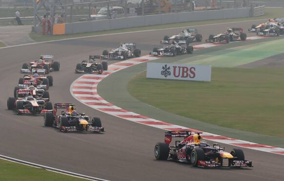 Red Bull driver Sebastian Vettel of Germany leads teammate Mark Webber of Australia at the start of the Indian Formula One Grand Prix at the Buddh International Circuit in Noida, on the outskirts of New Delhi.