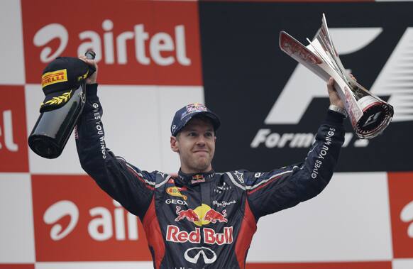 Red Bull driver Sebastian Vettel of Germany celebrates on the podium after winning the Indian Formula One Grand Prix at the Buddh International Circuit in Noida, on the outskirts of New Delhi.