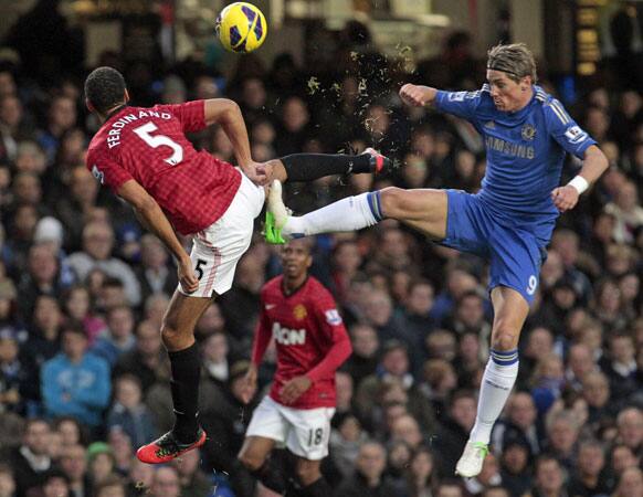 Chelsea's Fernando Torres, right, competes with Manchester United's Rio Ferdinand, during their English Premier League soccer match at Stamford Bridge, London, Sunday, Oct. 28, 2012.