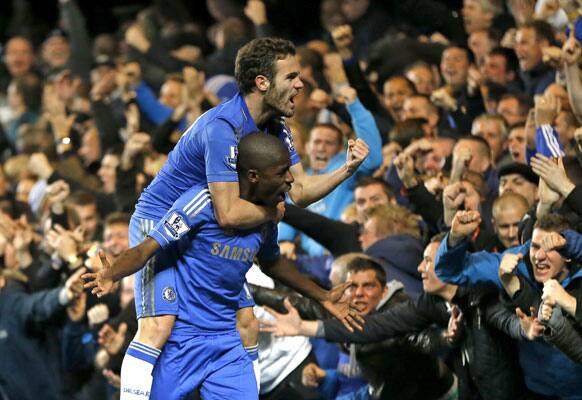 Chelsea's Ramires, below, and Juan Mata celebrate Ramires' goal during the English Premier League soccer match between Chelsea and Manchester United at Stamford Bridge Stadium.