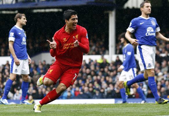 Liverpool's Luis Suarez, centre, celebrates after scoring against Everton, during their English Premier League soccer match at Goodison Park Stadium, in Liverpool, England, Sunday, Oct. 28, 2012.