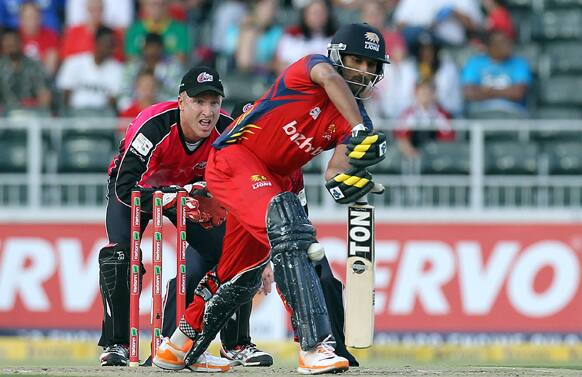 Highveld Lions' batsman Sohail Tanveer, right, plays LBW as Sydney Sixters' captain Brad Haddin, left, looks on, during the final of their Champions League Twenty20 cricket match at the Wanderers Stadium in Johannesburg, South Africa.