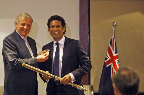 Minister for Regional Australia and Minister for the Arts Simon Crean displays the Order of Australia conferred upon Sachin Tendulkar during an event in Mumbai. Tendulkar was given the award for service to Australia-India relationship by promoting goodwill, friendship and sportsmanship.