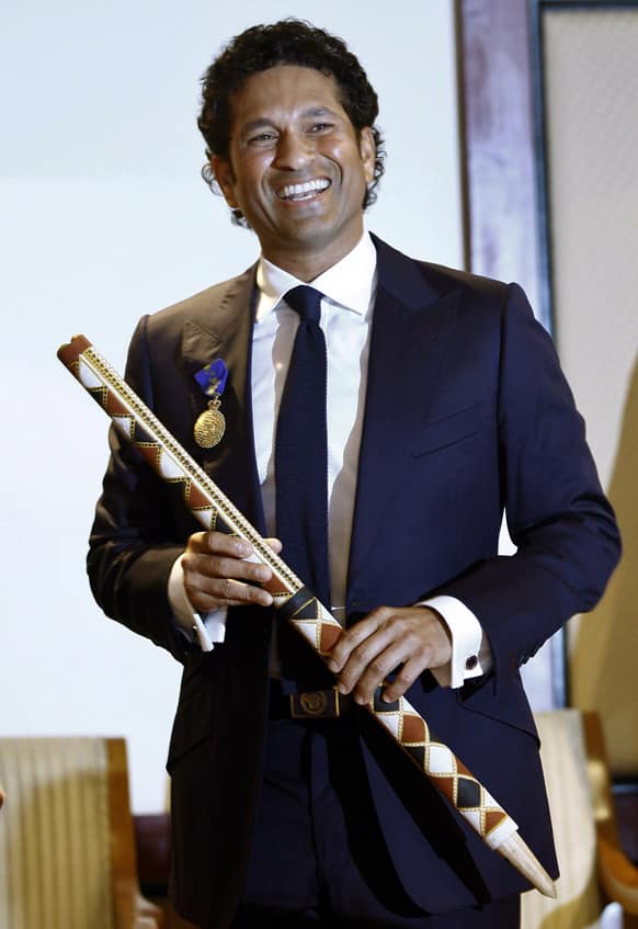 Sachin Tendulkar poses for photographs after receiving the Order of Australia at an event in Mumbai. Tendulkar was given the award for service to Australia-India relationship by promoting goodwill, friendship and sportsmanship.