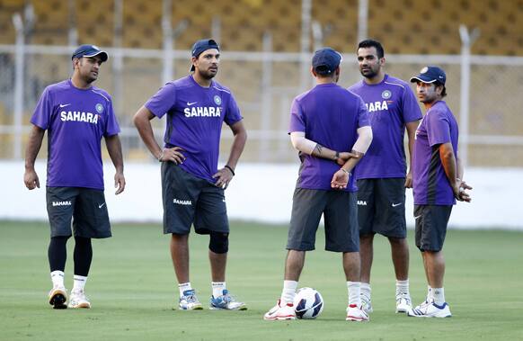 Indian cricketers, from left, captain Mahendra Singh Dhoni, Yuvraj Singh, Virat Kohli, back to camera, Zaheer Khan and Sachin Tendulkar, talk during a practice session in Ahmadabad.