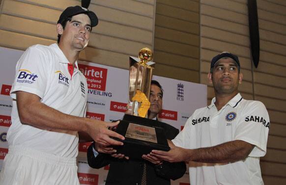 England's captain Alastair Cook and his Indian counterpart Mahendra Singh Dhoni, unveil the trophy ahead of their Test cricket series starting in Ahmedabad.