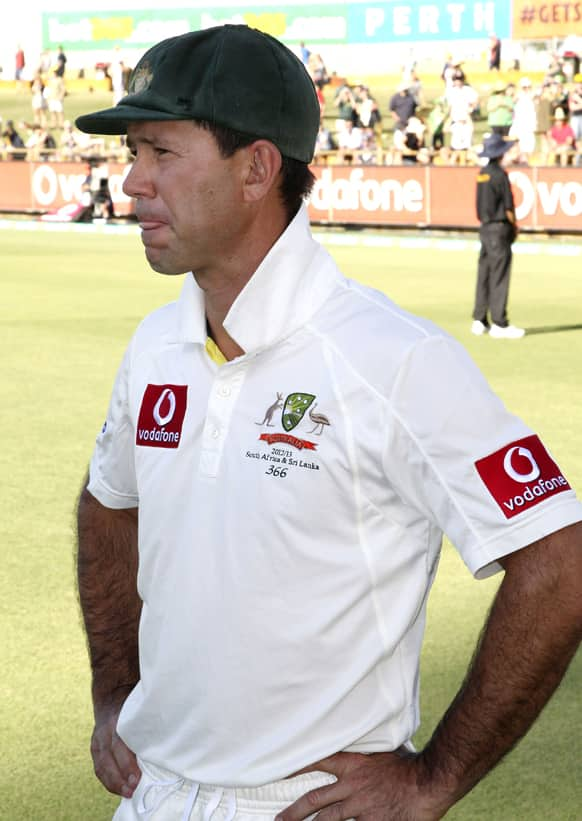 Australia's Ricky Ponting watches South Africa's players celebrate their win over Australia in the third cricket test match in Perth. Ponting is retiring from test cricket with this his last match. 