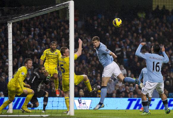 Manchester City's Edin Dzeko, centre right, narrowly misses to score with a header during his team's English Premier League soccer match against Reading at The Etihad Stadium, Manchester, England, Saturday Dec. 22, 2012.