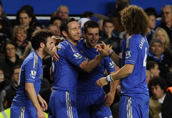 Chelsea's Frank Lampard, second left, celebrates scoring his side's fourth goal with his teammates, from left, Juan Mata, Cesar Azpilicueta and David Luiz during the English Premier League soccer match between Chelsea and Aston Villa at Stamford Bridge in London, Sunday, Dec. 23, 2012.