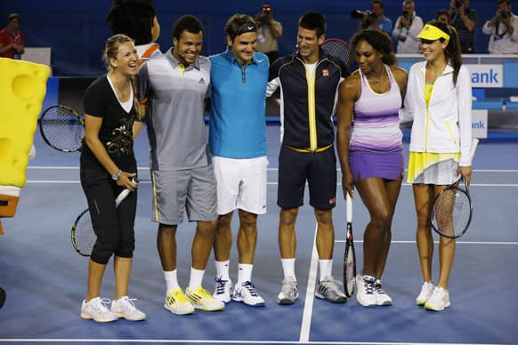 Victoria Azarenka of Belarus, France's Jo-Wilfried Tsonga, Switzerland's Roger Federer, Serbia's Novak Djokovic, Serena Williams of the US and Serbia's Ana Ivanoic pose for a group photo following an exhibition match on Rod Laver Arena during the Kids Tennis Day at Melbourne Park. 