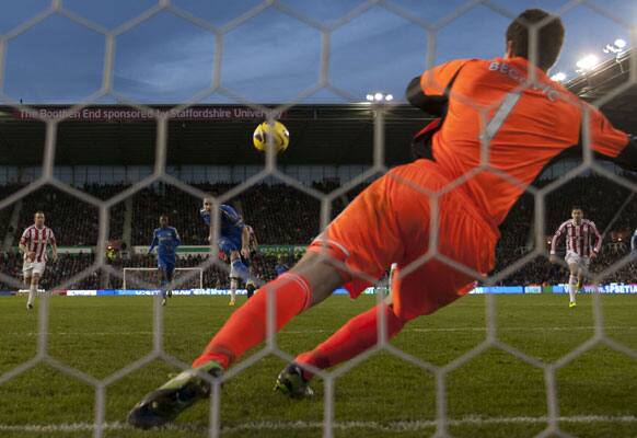 Chelsea's Frank Lampard, center, scores a penalty past Stoke City goalkeeper Asmir Begovic during their English Premier League soccer match at the Britannia Stadium, Stoke, England, Saturday Jan. 12, 2013.