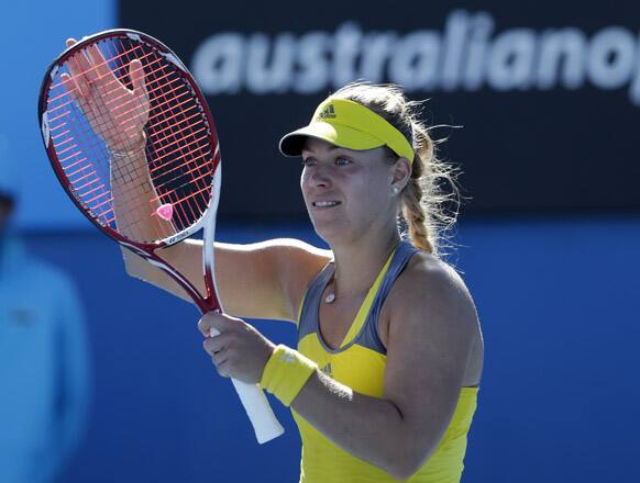 Germany's Angelique Kerber celebrates after winning her first round match against Ukraine's Elina Svitolina at the Australian Open tennis championship in Melbourne.