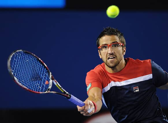 Serbia's Janko Tipsarevic reaches for a return to Australia's Lleyton Hewitt in their first round match at the Australian Open tennis championship in Melbourne.