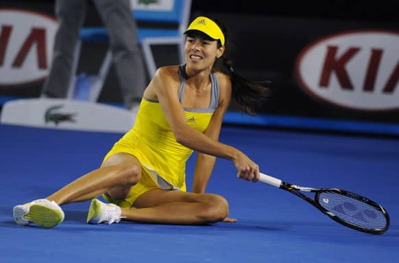 Serbia's Ana Ivanoic falls to the court during her first round match against Hungary's Melinda Czink at the Australian Open tennis championship in Melbourne.