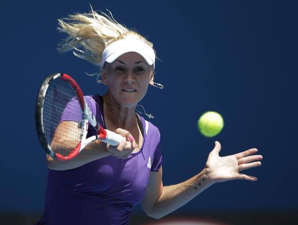 Olga Govortsova of Belarus hits forehand return to China's Li Na during their second round match at the Australian Open tennis championship.