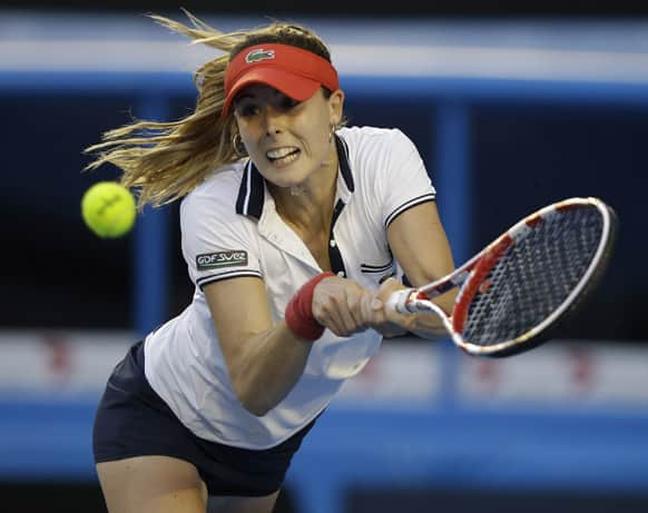 Alize Cornet of France hits a return to Venus Williams of the US in their second round match at the Australian Open tennis championship in Melbourne.