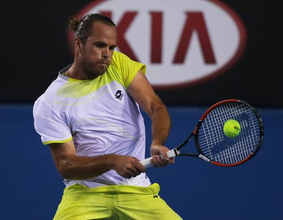 Belgium's Xavier Malisse hits a return to Spain's Fernando Verdasco during their second round match at the Australian Open tennis championship in Melbourne.