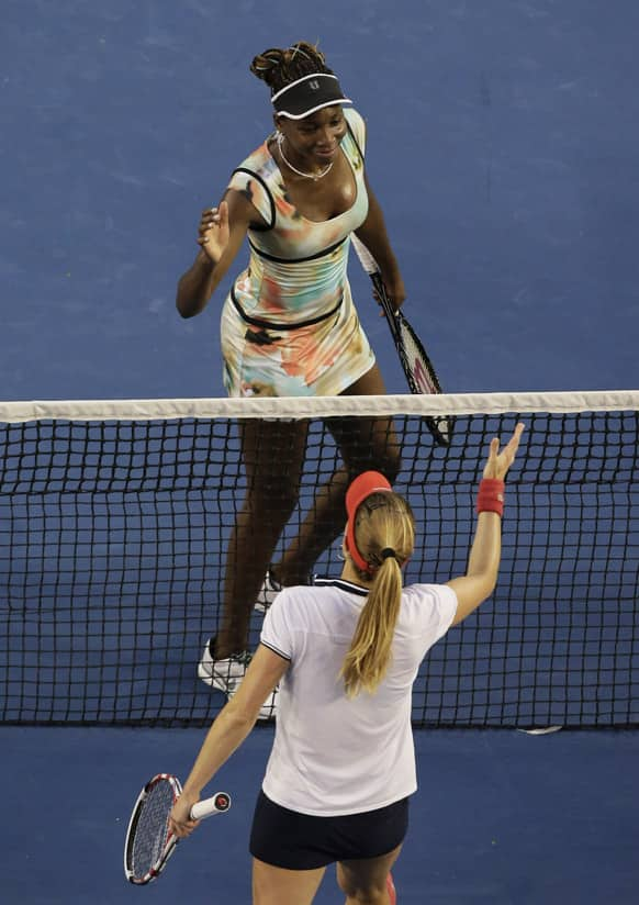 Venus Williams of the US, top, is congratulated by France's Alize Cornet after Williams won their second round match at the Australian Open tennis championship in Melbourne.