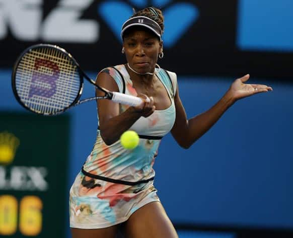 Venus Williams of the US makes a forehand return to Russia's Maria Sharapova during their third round match at the Australian Open tennis championship in Melbourne.