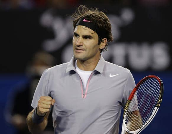 Switzerland's Roger Federer reacts during his third round match against Australia's Bernard Tomic at the Australian Open tennis championship in Melbourne.